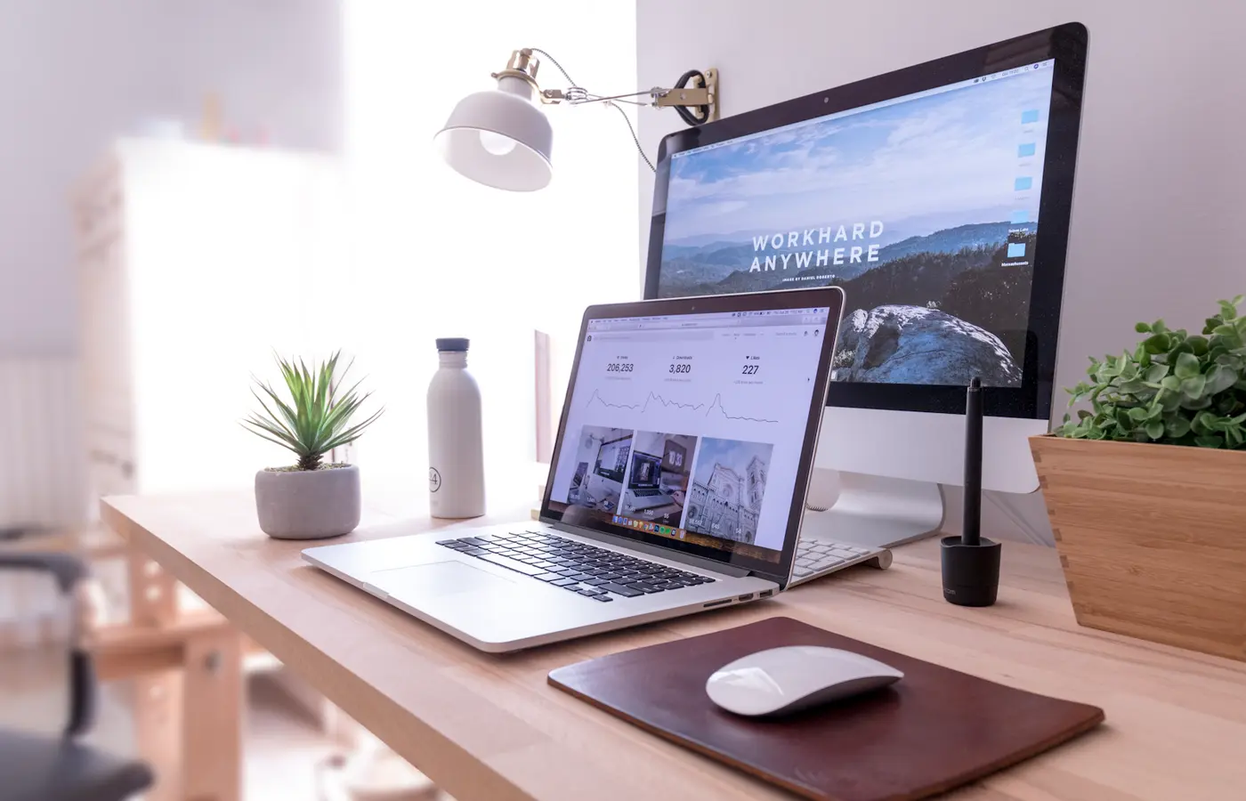 Laptop connected to two external monitors on a desk