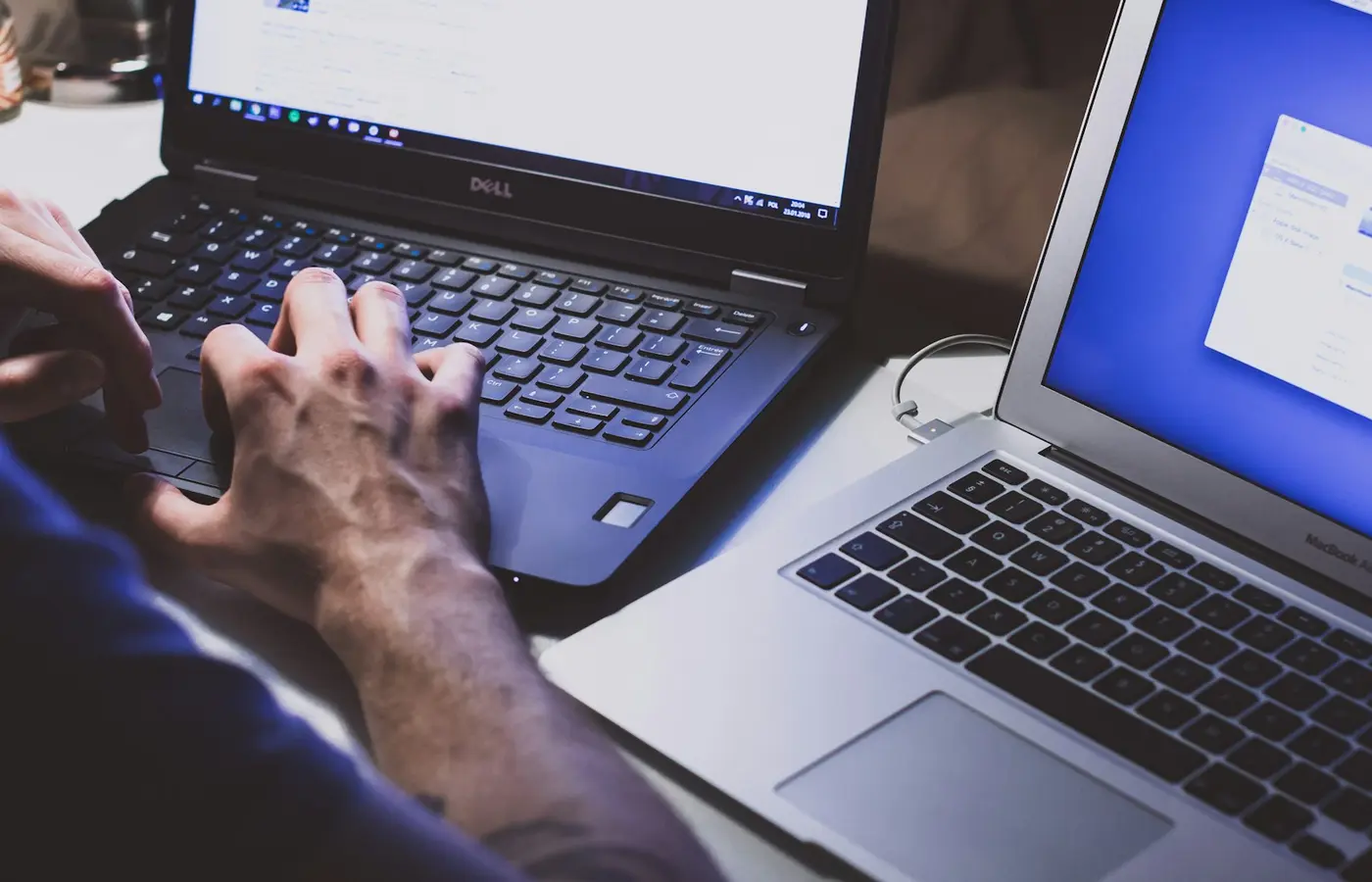 Three laptops on a workspace representing Windows, macOS, and ChromeOS